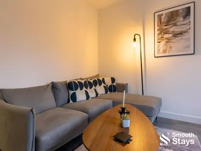 a living room with a couch and a table at Modern 2 Bed Apartment By Smooth Stays Short Lets & Serviced Accommodation Preston With Parking Near Train Station in Preston