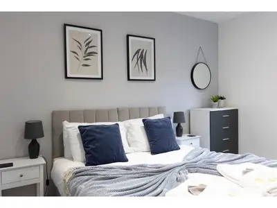 a white bedroom with a bed with blue pillows at Modern 2 Bed Apartment By Smooth Stays Short Lets & Serviced Accommodation Preston With Parking Near Train Station in Preston