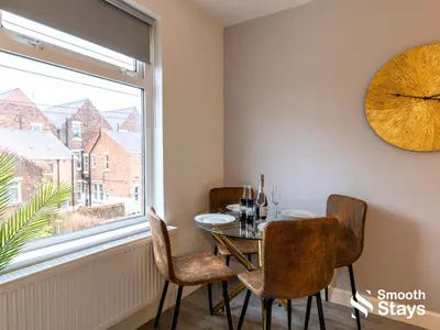 a dining room with a table and chairs and a window at Modern 2 Bed Apartment By Smooth Stays Short Lets & Serviced Accommodation Preston With Parking Near Train Station in Preston