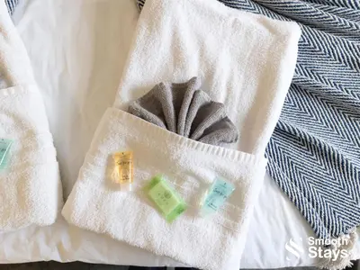 a white towel with a gray scarf on a bed at Modern 2 Bed Apartment By Smooth Stays Short Lets & Serviced Accommodation Preston With Parking Near Train Station in Preston