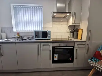 a kitchen with a counter top with a microwave at 'The Love Nest' Apartment Liverpool, Netflix in Liverpool