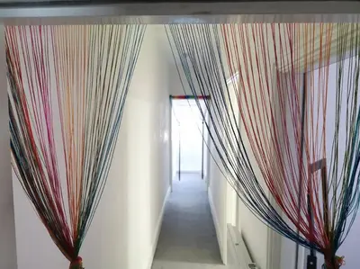a hallway with curtains hanging from a wall at 'The Love Nest' Apartment Liverpool, Netflix in Liverpool