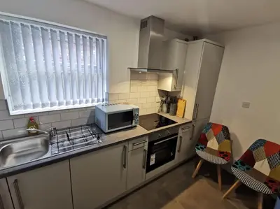 a kitchen with a sink and a microwave at 'The Love Nest' Apartment Liverpool, Netflix in Liverpool