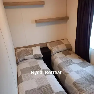 two beds in the corner of a room at Rydal Retreat Lakeland Holiday Park in Flookburgh