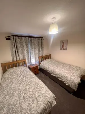 a bedroom with two beds and a window at Braffin @ Fellside Farm, Pennington, Ulverston in Pennington