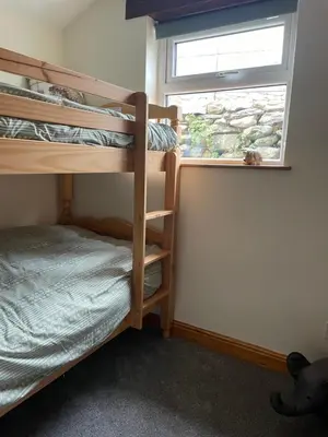 a bedroom with two bunk beds and a window at Braffin @ Fellside Farm, Pennington, Ulverston in Pennington
