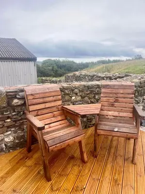 two wooden benches sitting on top of a deck at Braffin @ Fellside Farm, Pennington, Ulverston in Pennington
