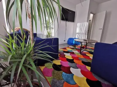 a room with a couch and a colorful rug at The Bob Marley 'One Love' Apartment, Relaxed Vibes in Liverpool