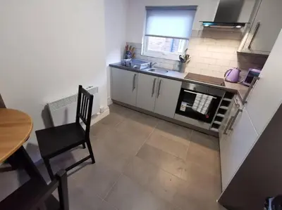 a small kitchen with a table and a table and a chair at The Bob Marley 'One Love' Apartment, Relaxed Vibes in Liverpool