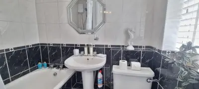 a bathroom with a sink and a toilet and a mirror at Toffees Townhouse a 2 Bed House in Liverpool 1 Mins walk to Goodison Park in Liverpool