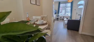 a living room with a table and a dining room at Toffees Townhouse a 2 Bed House in Liverpool 1 Mins walk to Goodison Park in Liverpool