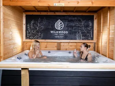 two girls are sitting in a jacuzzi tub at Higher Trapp Hotel in Burnley