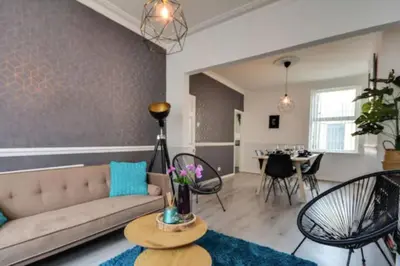 a living room with a couch and a table at Antonio str Liverpool 6 beds in Liverpool