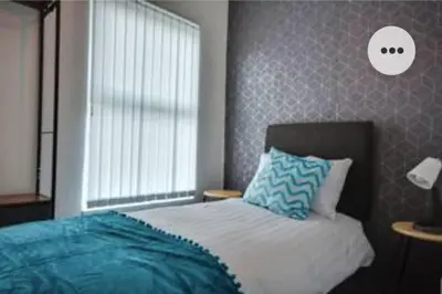 a bedroom with a bed and a window at Antonio str Liverpool 6 beds in Liverpool