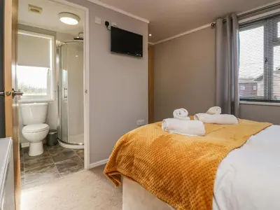 a bedroom with a bed with towels on it at Lakeside 20 in Carnforth