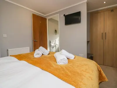 a bedroom with a bed with towels on it at Lakeside 20 in Carnforth
