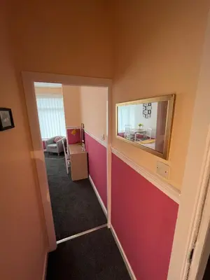 a hallway with a mirror and a room at Blackpool Rocks Pleasure Beach in Blackpool