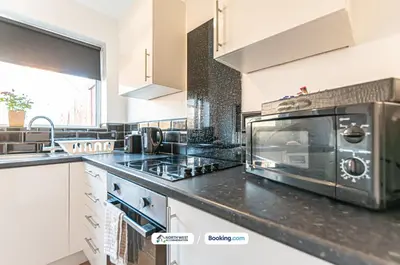 a kitchen with a counter top with a microwave at Fully Furnished 3 Bedroom House in Preston with Free Parking in Preston