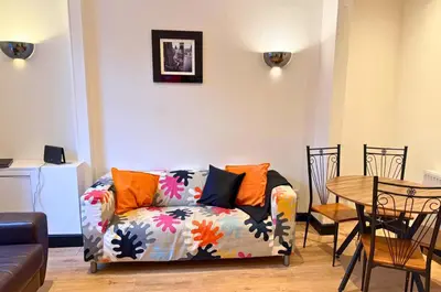 a living room with a couch and a table at Fully Furnished 3 Bedroom House in Preston with Free Parking in Preston