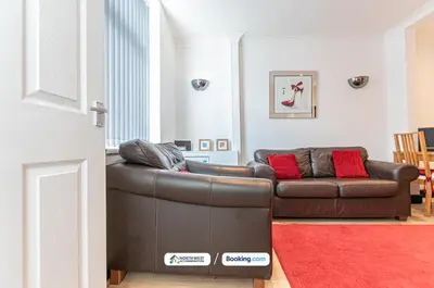 a living room with a brown leather couch and a red rug at Fully Furnished 3 Bedroom House in Preston with Free Parking in Preston