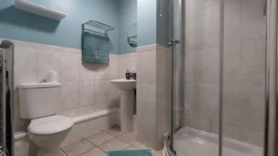 a bathroom with a toilet and a sink and a shower at Modern 1-Bed Flat in Wigan in Wigan