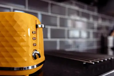 a yellow toaster sitting on top of a counter at Brown Ball in Barrow in Furness