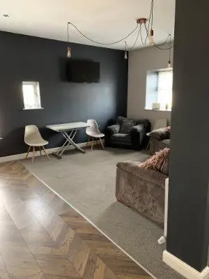a living room with a couch and a table at Apartments on Albert Road with free parking in Blackpool