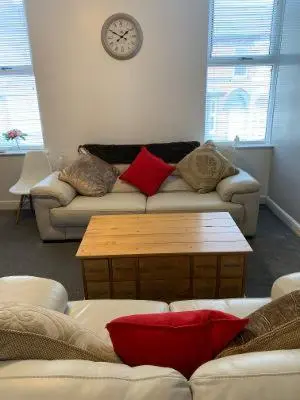 a living room with a couch and a coffee table at Apartments on Albert Road with free parking in Blackpool