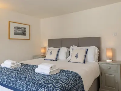 a bedroom with a bed with towels on it at Caton Lane House in Grange Over Sands