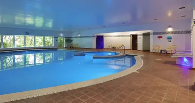 a large swimming pool in a hotel room at Barton Manor Hotel & Spa; BW Signature Collection in Preston