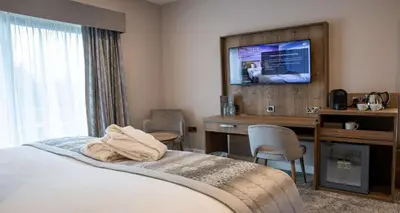 a hotel room with a bed and a desk and a television at Barton Manor Hotel & Spa; BW Signature Collection in Preston