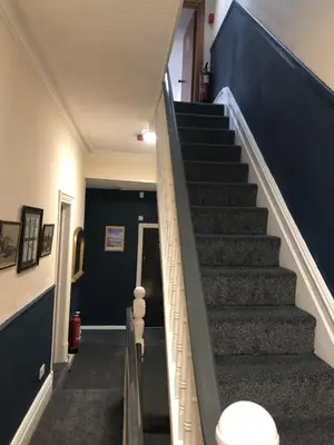 a staircase in a house with a blue wall at Bronte House - Blackpool in Blackpool