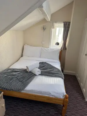a bed with a stuffed animal laying on it at Bronte House - Blackpool in Blackpool