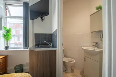 a small bathroom with a sink and a toilet at Driftwood Rooms in Blackpool