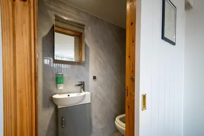 a bathroom with a sink and a toilet at Driftwood Rooms in Blackpool