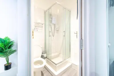 a bathroom with a toilet and a shower at Driftwood Rooms in Blackpool