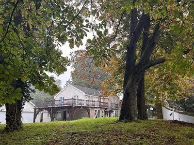 a large house with a deck and a tree at Fulwood House in Grimsargh