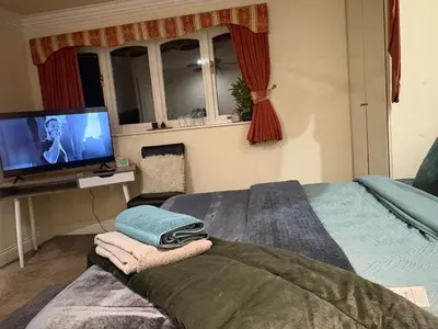 a bedroom with a bed and a tv in it at Fulwood House in Grimsargh