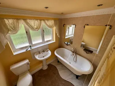 a bathroom with a sink and a tub and a toilet at Fulwood House in Grimsargh