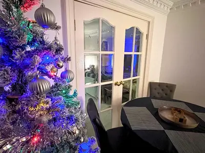 a purple christmas tree in a dining room with a table at Fulwood House in Grimsargh