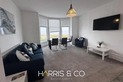 a living room with a couch and a table at New Sandpiper Apartments in Fleetwood