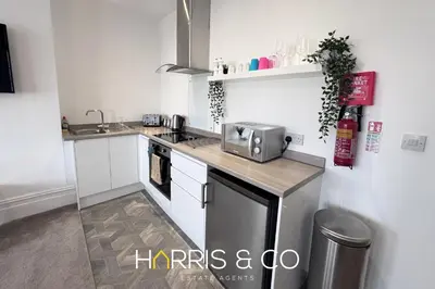 a kitchen with a sink and a microwave at New Sandpiper Apartments in Fleetwood