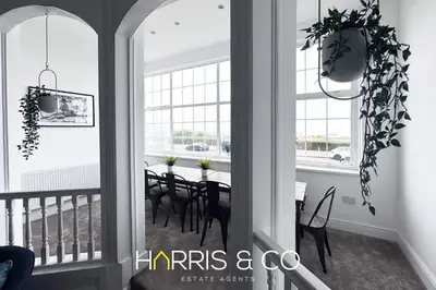 a dining room with a table and chairs at New Sandpiper Apartments in Fleetwood