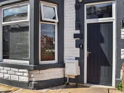 a black door and windows on a house at No10 Apartments in Blackpool