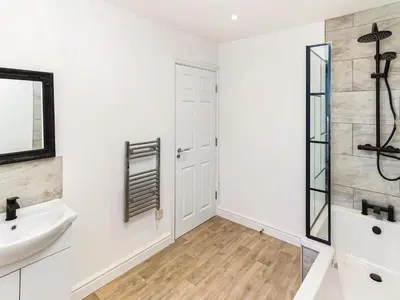 a white bathroom with a sink and a mirror at No10 Apartments in Blackpool