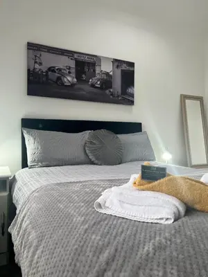 a bedroom with a bed with a picture on the wall at The Annexe, St Andrews house hotel, Two bedrooms Sleeps 4 in Preston