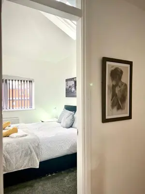 a bedroom with a bed and a picture on the wall at The Annexe, St Andrews house hotel, Two bedrooms Sleeps 4 in Preston