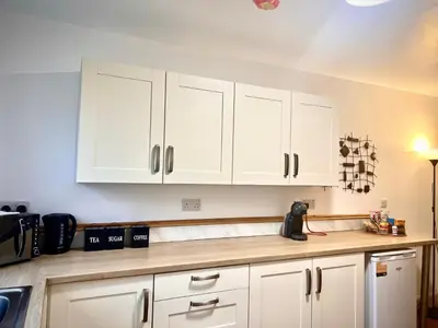 a kitchen with white cabinets and a counter top at The Annexe, St Andrews house hotel, Two bedrooms Sleeps 4 in Preston