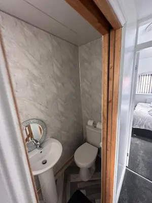 a small bathroom with a sink and a toilet at The Annexe, St Andrews house hotel, Two bedrooms Sleeps 4 in Preston