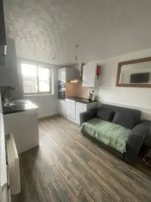a living room with a couch and a kitchen at Lovely flat in heart Blackpool in Blackpool